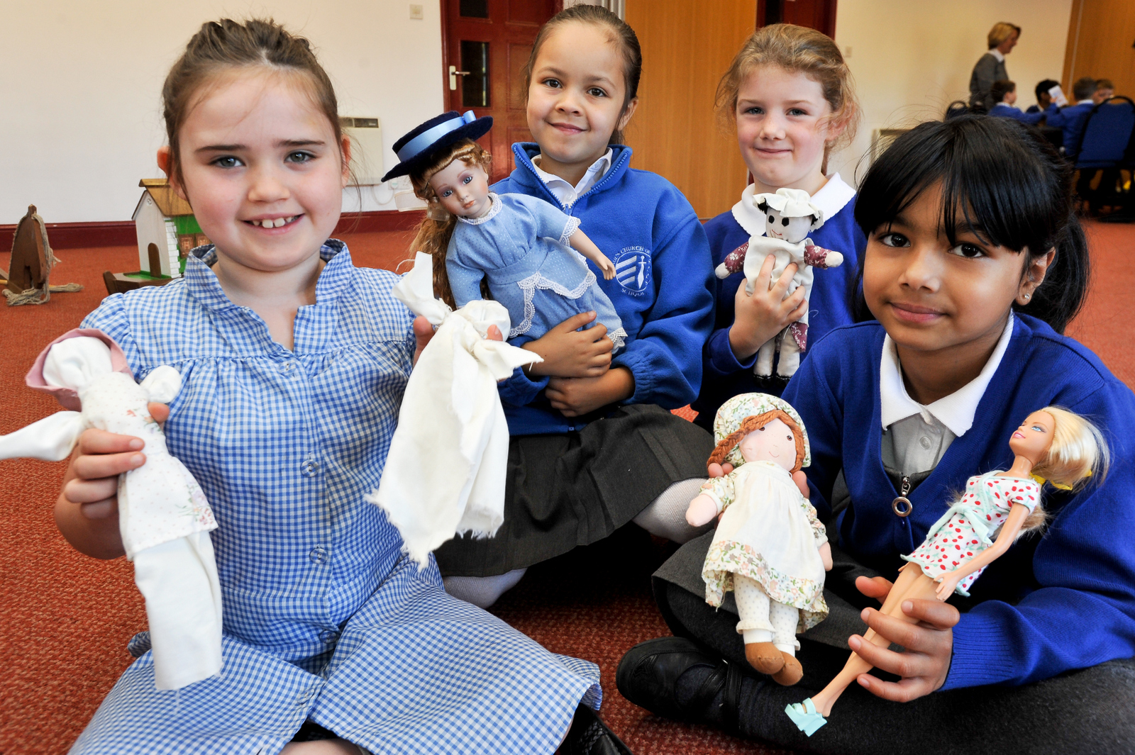 Key Stage one students enjoying playing with old fashioned dolls