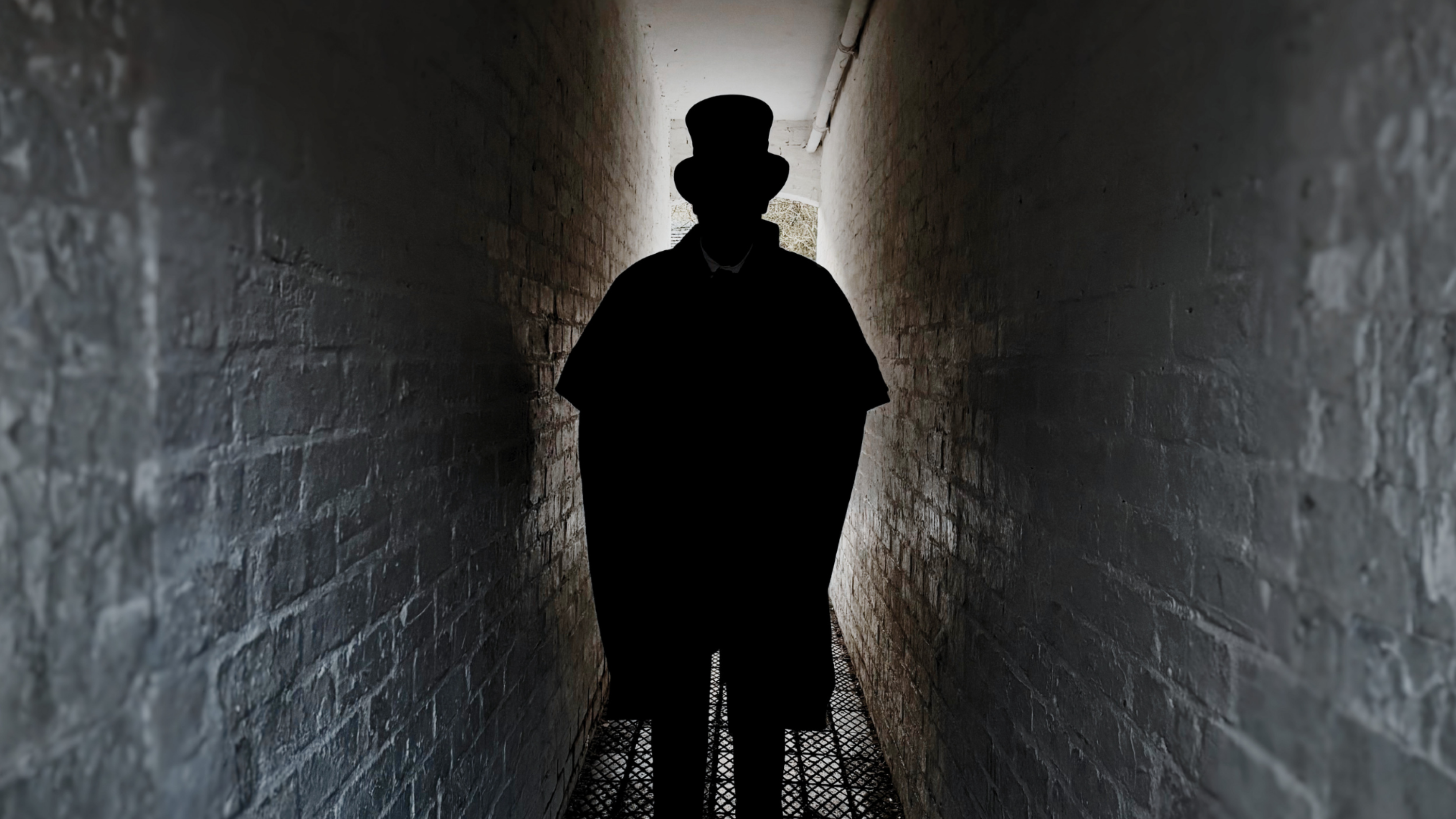 A sinister looking historic character drapped in shadow