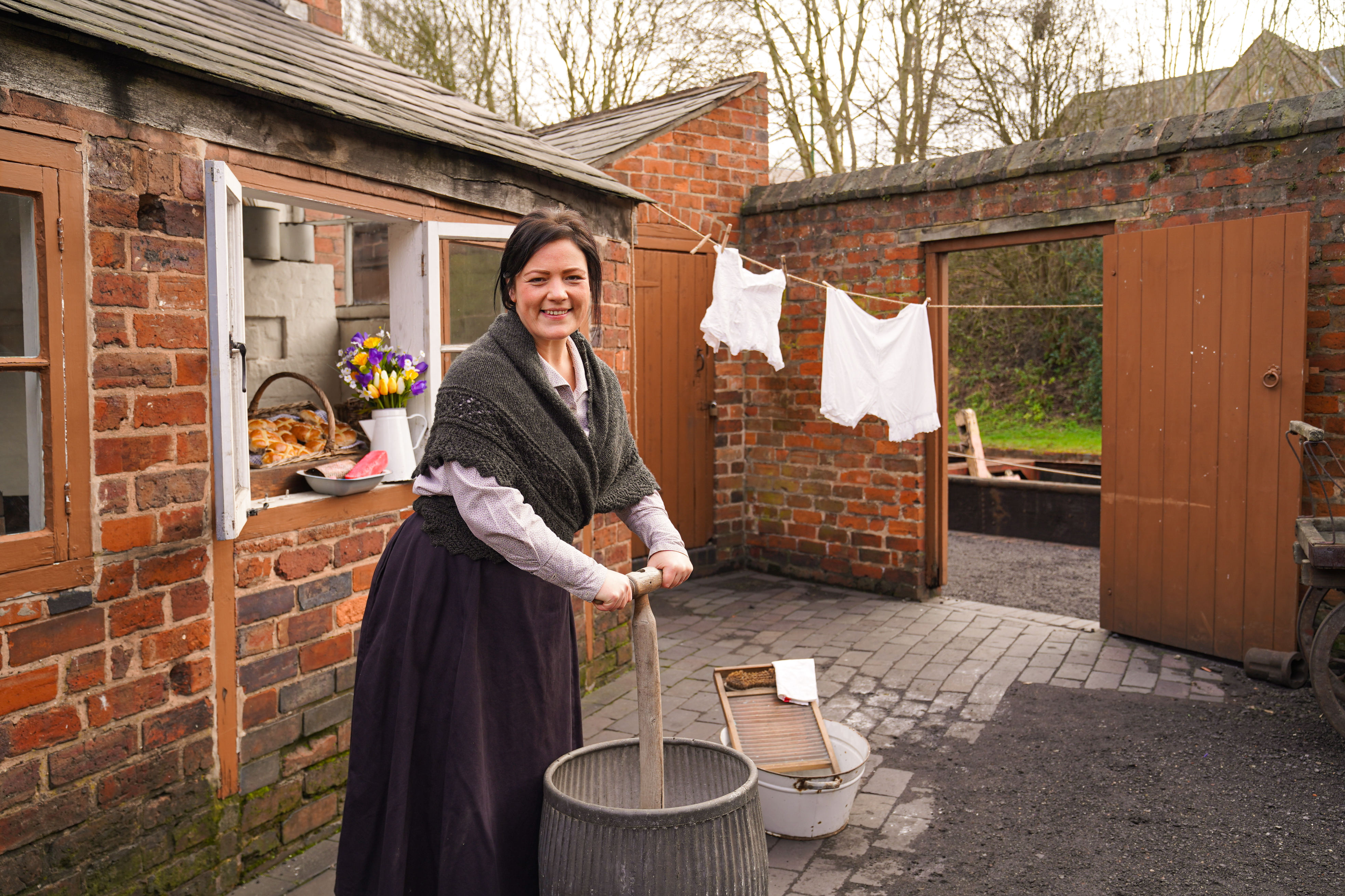 Edwardian lady carrying out her laundry with a Dolly tub and plunger