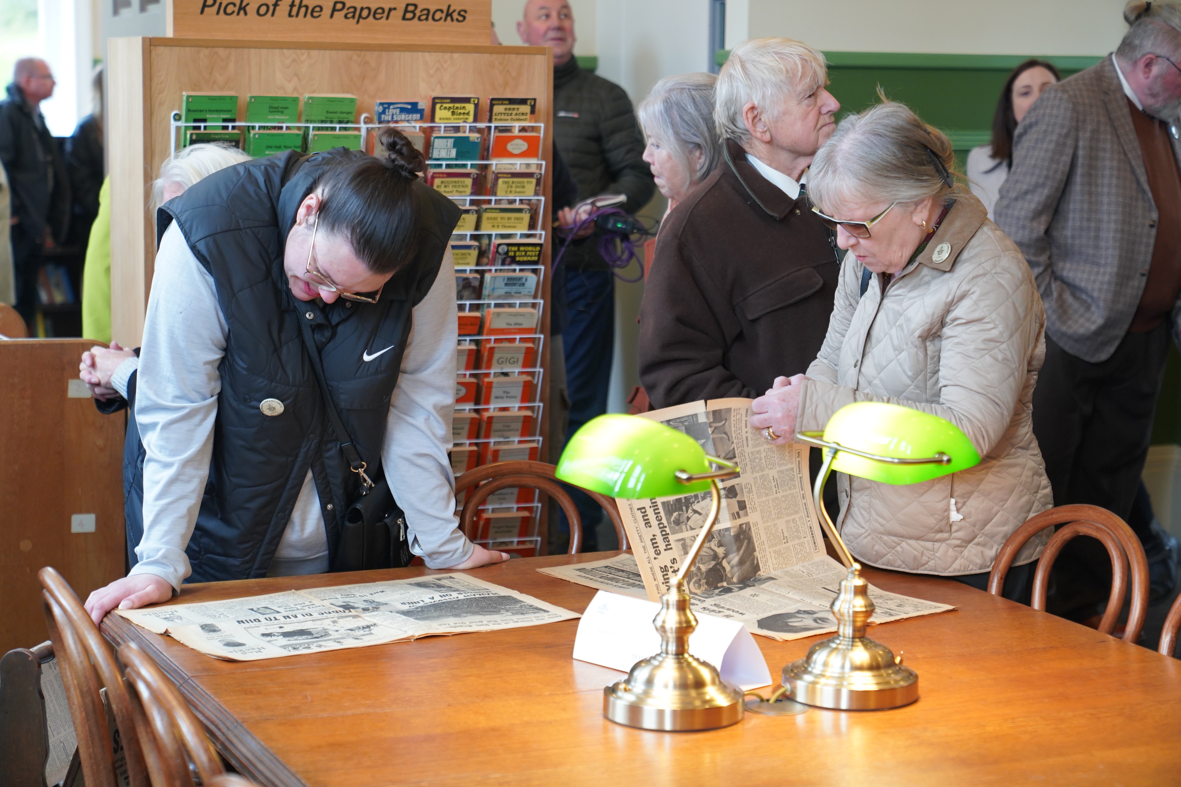 visitors inside Wooside Library reading newspapers